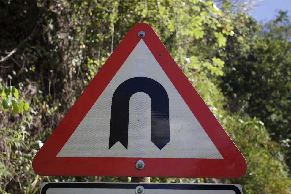U turn road sign to represent government annoucements